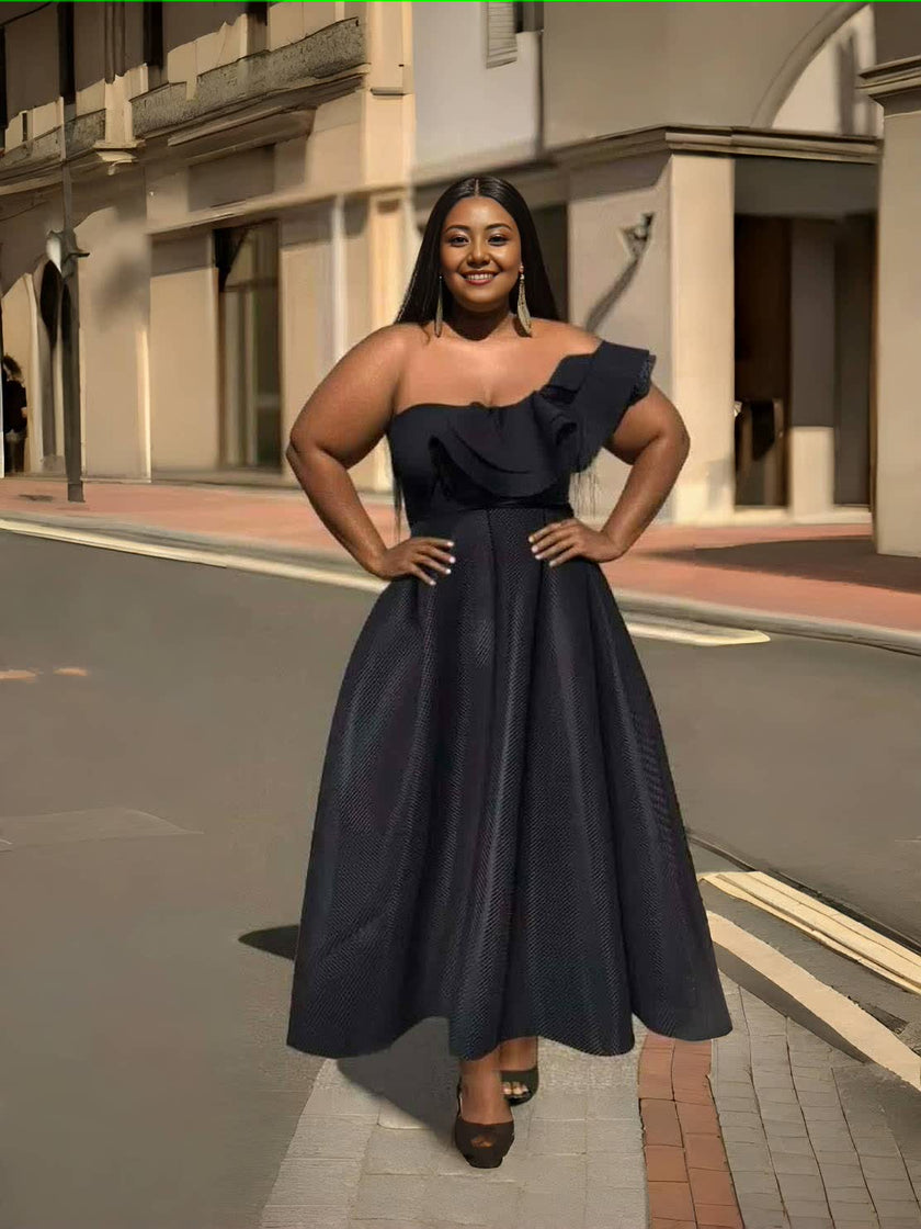 One-shoulder ruffle evening dress with dark textured skirt and fitted waist.