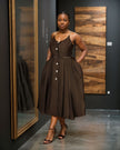 Black sleeveless A-line midi dress with button front and waist belt