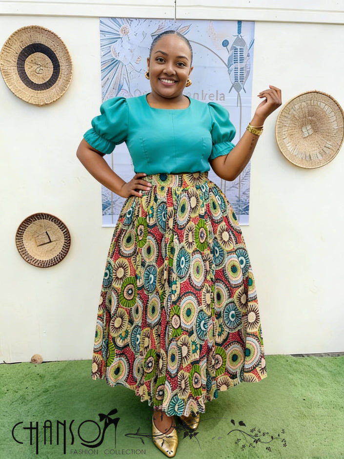 Green puff-sleeve top and patterned African print midi skirt twin set