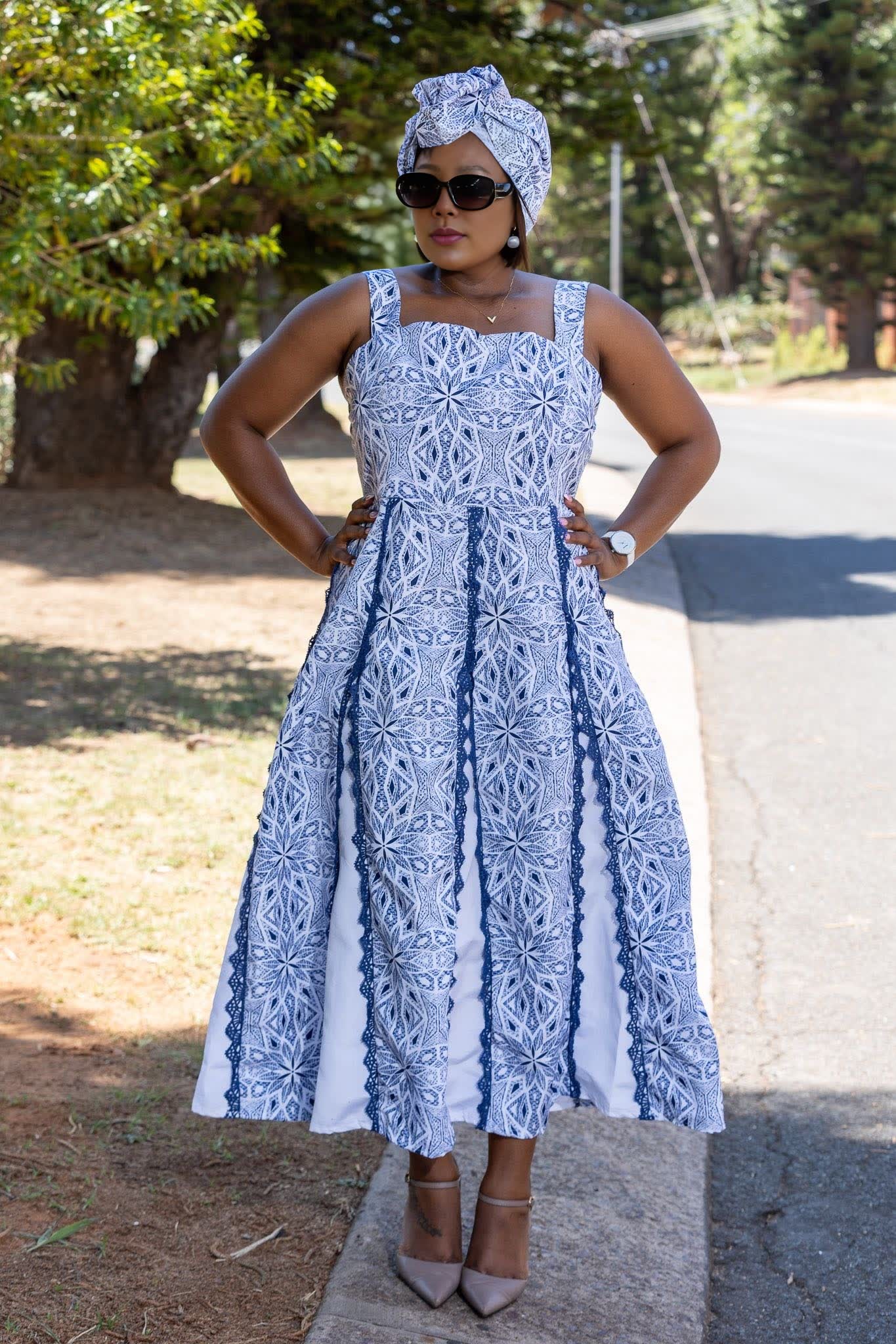 Blue geometric sleeveless maxi dress with square neckline and pleated skirt