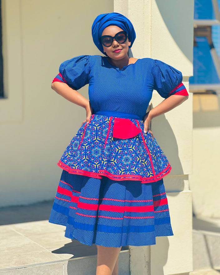 Blue puff-sleeve dress with patterned skirt and red trim