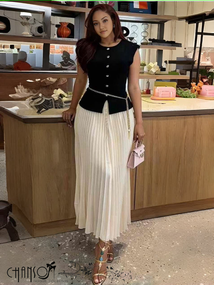 Black knit midi dress with pleated skirt, sleeveless button front and waist belt
