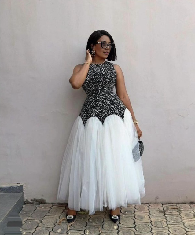 Evening dress with black printed bodice and layered white tulle skirt, sleeveless