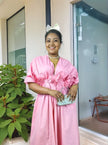 Pink floral maxi dress with puff sleeves and A-line skirt, V-neck.