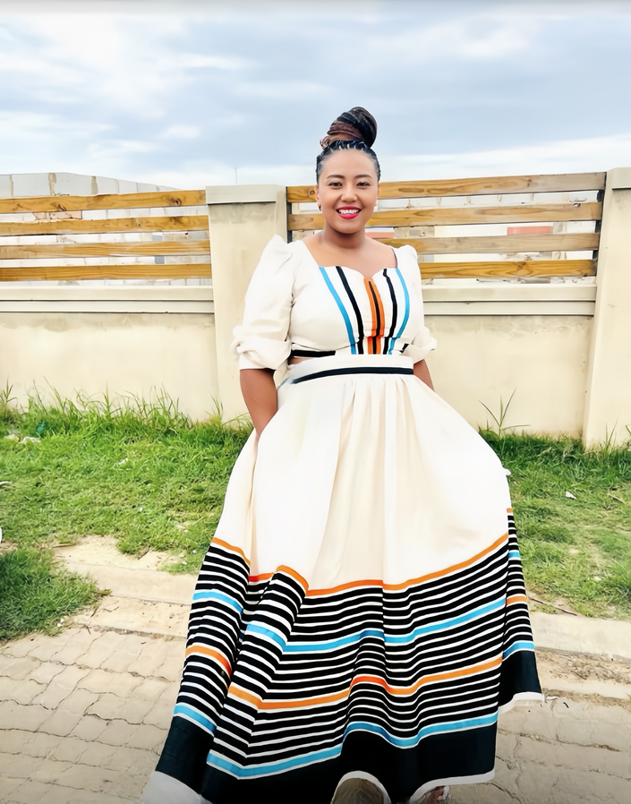 Cream maxi dress with puff sleeves and multicolor striped hem