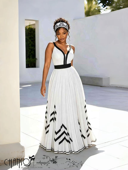 White V-neck maxi dress with black waist band, pleated skirt and geometric arrow motif