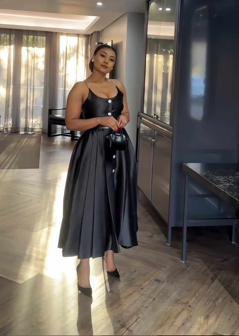 Black sleeveless A-line midi dress with round neckline and button placket