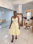 Cream sleeveless A-line midi dress with button front and waist belt