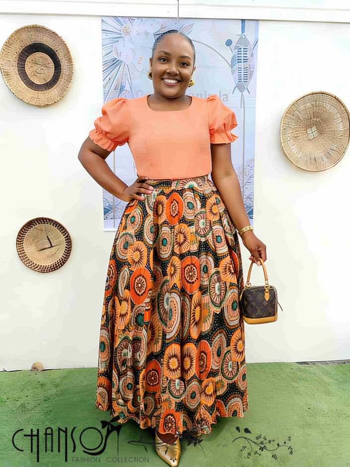 Coral puff-sleeve top and patterned African print midi skirt twin set