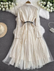 White lace midi dress with long sleeves, belt, and layered tulle flared skirt