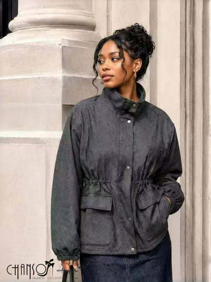 Dark gray utility jacket with stand collar, snap buttons, drawstring waist, and flap pockets