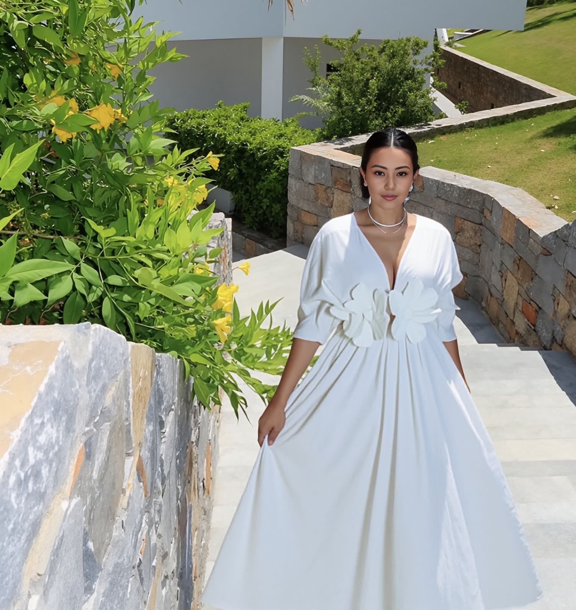 White floral maxi dress with puff sleeves and A-line skirt, V-neck.