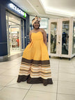 Strapless maxi dress with flared skirt in mustard yellow and dark striped hem
