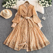 Tan lace mini dress with button front, long puff sleeves, and round-buckle belt