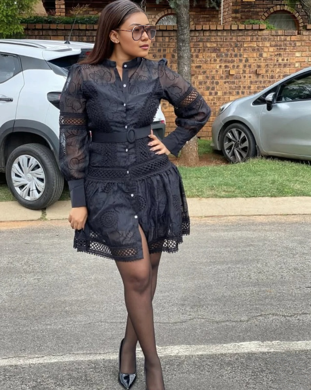 Black layered lace mini dress with puff sleeves, button front, and belted waist