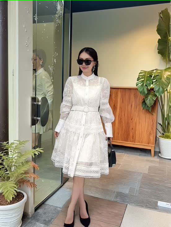 White lace mini dress with long puff sleeves, button front, and cinched belt waist