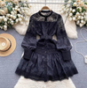 Black lace mini dress with puff sleeves, button front, tiered skirt, and belt