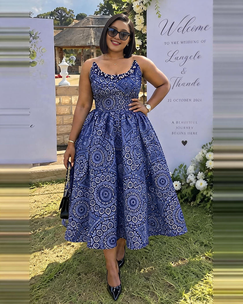 Blue beaded sleeveless midi dress with circular patterned bodice and full skirt