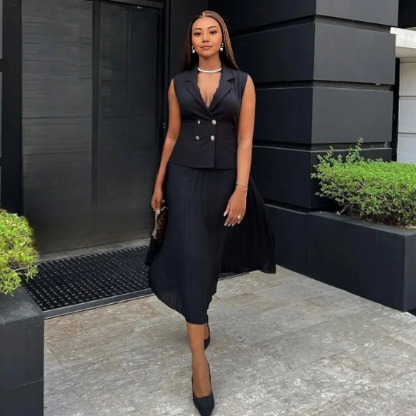Black belted sleeveless blazer and pleated midi skirt set, buttoned front