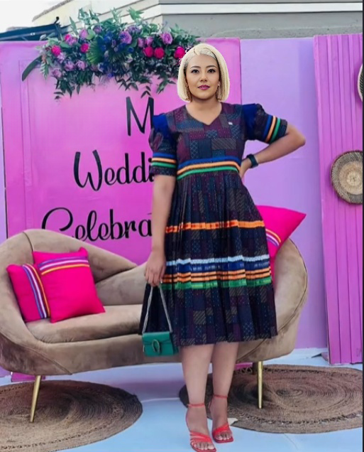Navy midi dress with colorful heritage stripes, puff sleeves, and V-neck