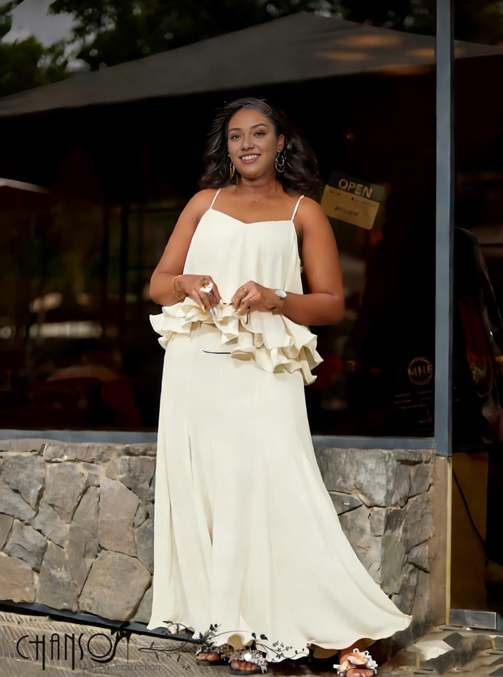 Cream layered ruffle evening dress with spaghetti straps and tiered skirt
