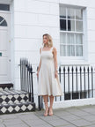 Beige sleeveless square-neck midi dress with fitted bodice and flared skirt
