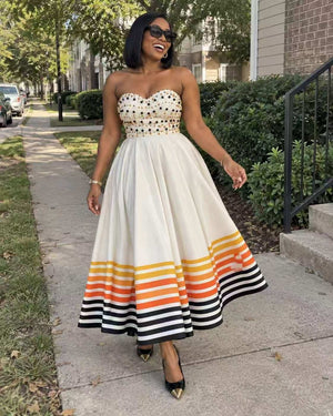 Ivory strapless sweetheart midi dress with beaded bodice and orange striped hem