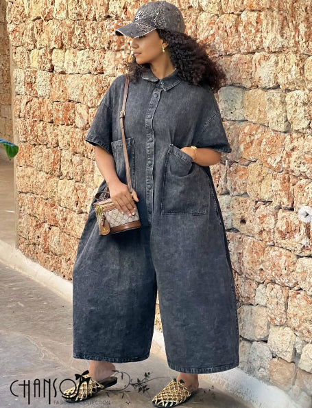 Dark denim jumpsuit with collared short sleeves and side pockets, wide leg fit