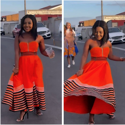 Orange bandeau dress with vertical front zip and striped ruffle hem