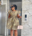 Gold A-line dress with puff sleeves, ornate embroidery and round neckline