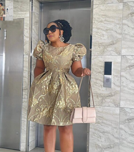 Gold A-line dress with puff sleeves, ornate embroidery and round neckline