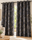 Black eyelet curtains with abstract speckled pattern, hung on dark metal grommets
