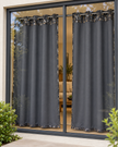 Dark gray eyelet curtains with abstract speckled border, hung on black metal grommets