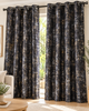 Black eyelet curtains with abstract speckled pattern, hung on dark metal grommets