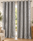 Light gray eyelet curtains with abstract speckled pattern, hung on gray metal grommets