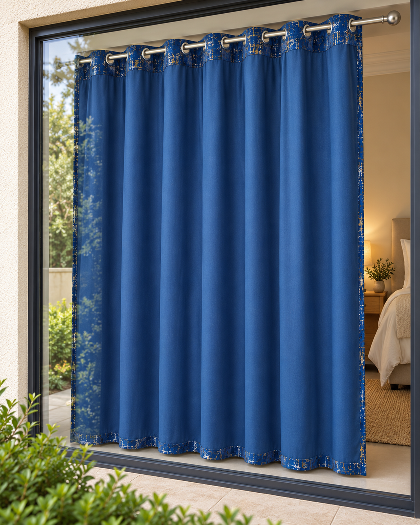 Blue eyelet curtains with abstract speckled pattern, hung on cobalt metal grommets
