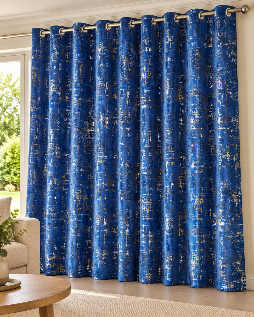 Royal blue eyelet curtains with abstract speckled pattern, hung on blue metal grommets