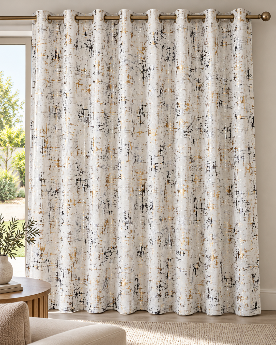 Cream white eyelet curtains with abstract speckled pattern, hanging from top bronze rings