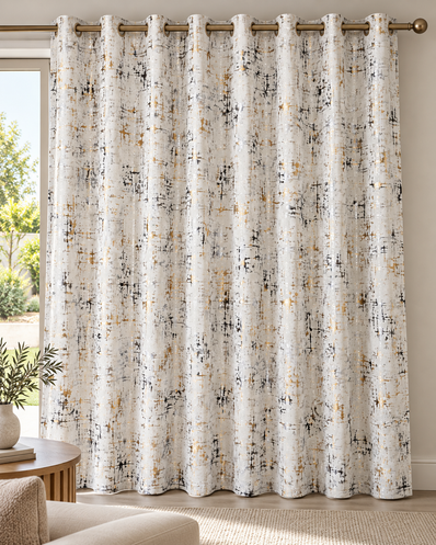 Cream white eyelet curtains with abstract speckled pattern, hanging from top bronze rings
