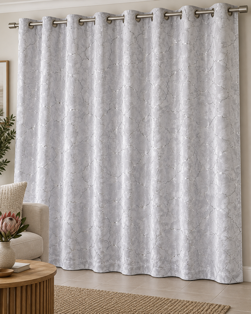 White blackout curtain with eyelet rings and a textured geometric cracked-lattice pattern