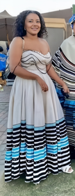 Sleeveless maxi dress with wavy striped hem in black, white, and blue