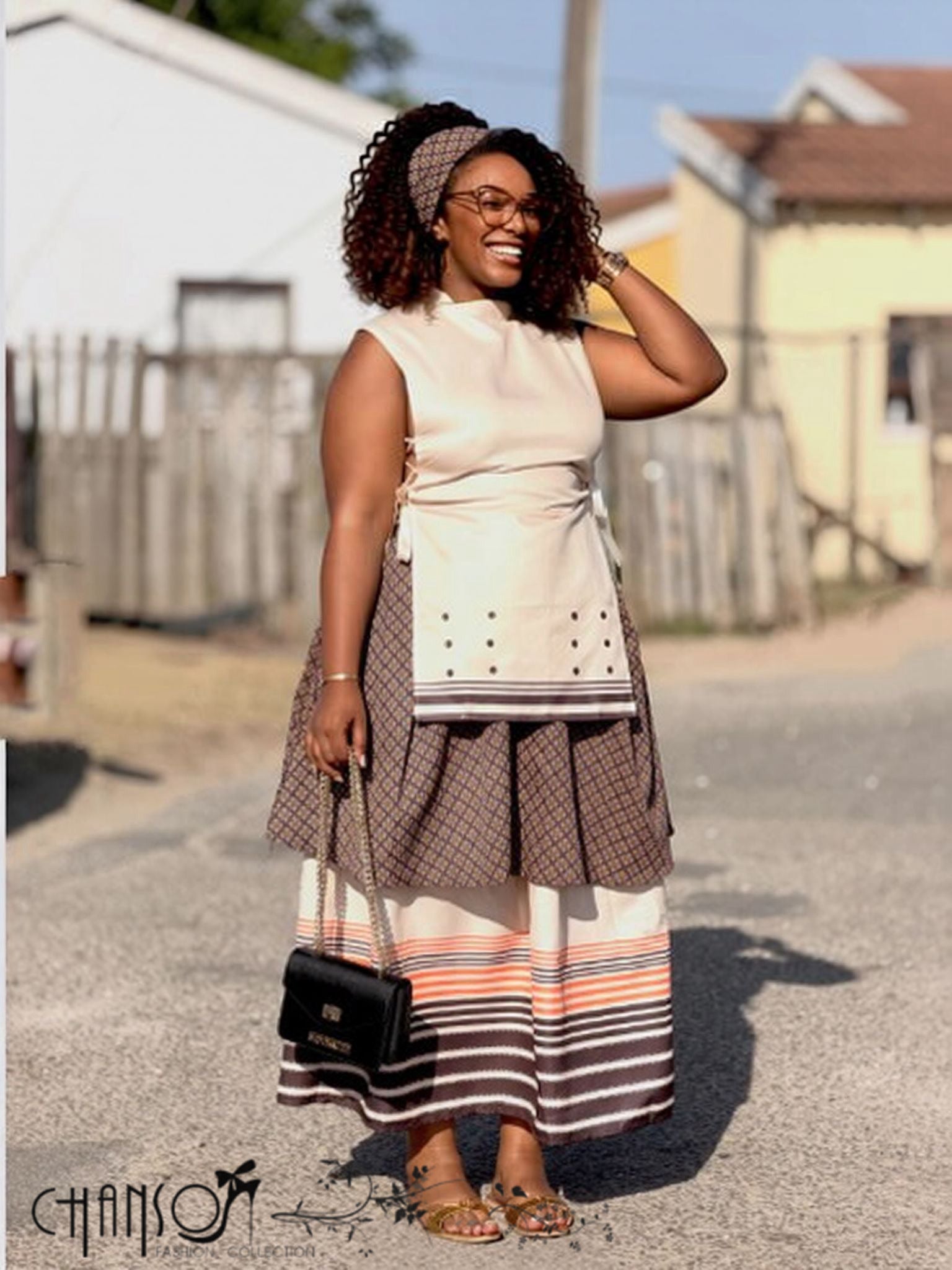 Sleeveless cream layered maxi dress with gathered waist tie and patterned tiered skirt