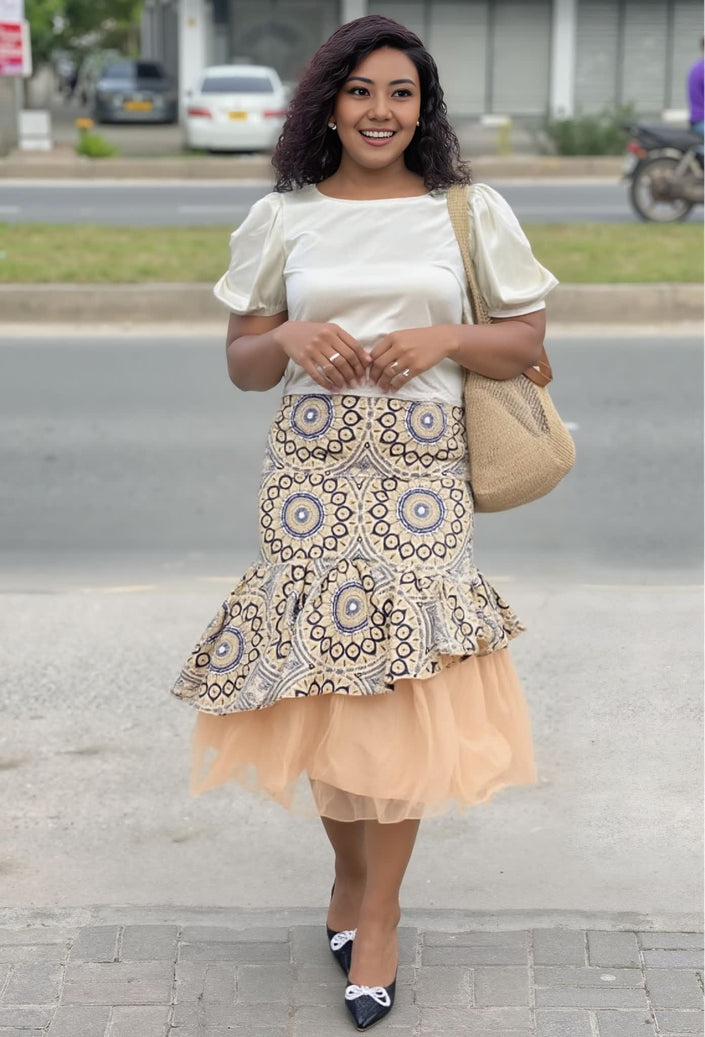 Peach puff-sleeve blouse with layered patterned skirt and tulle hem