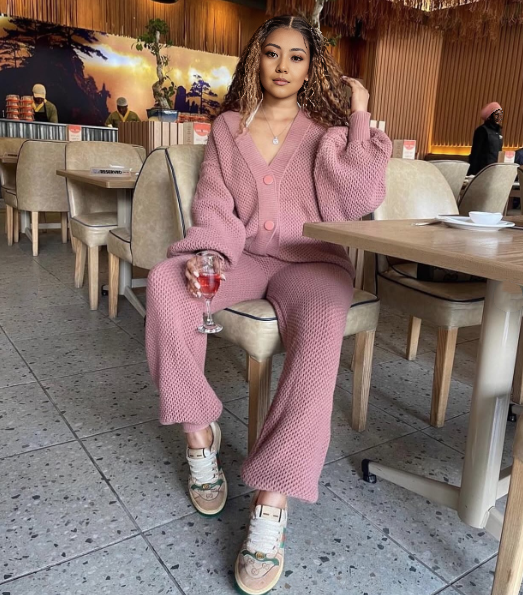 Mauve-pink knit twin set with button-front cardigan and matching knit pants.
