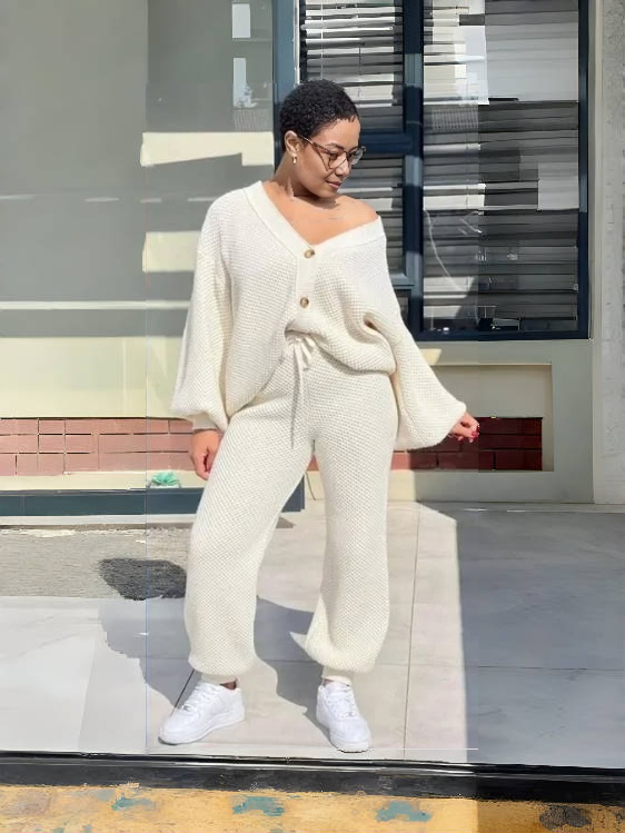 Cream knit twin set with button-front cardigan and matching knit pants.