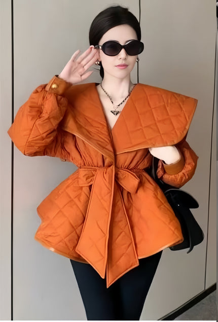 Orange-red belted puffy jacket with quilted shoulders and wide angled collar