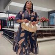Geometric puff-sleeve maxi dress with tie waist and tiered ruffle hem in navy and beige