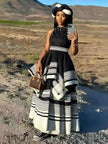Black beaded sleeveless maxi dress with layered striped skirt, high neckline
