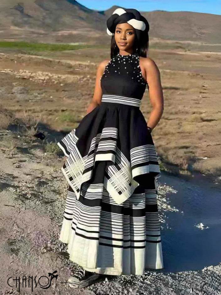Black beaded sleeveless maxi dress with layered black-and-white striped skirt