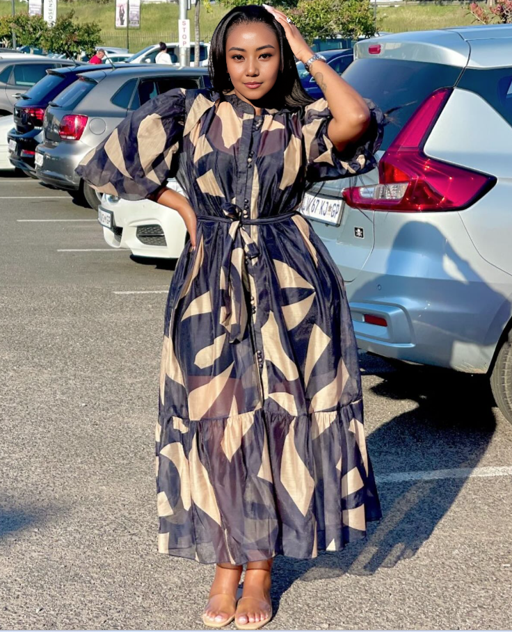 Patterned maxi dress with puff sleeves, tie waist, and button front in navy and beige